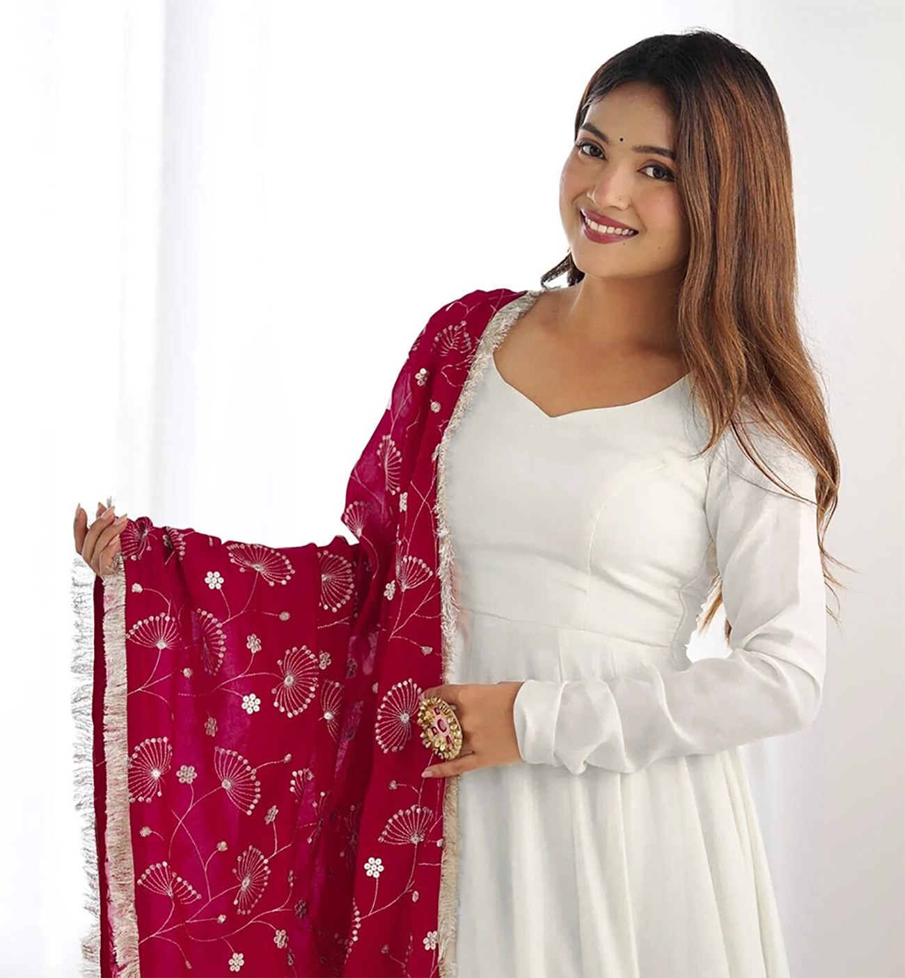 Elegant plain white georgette anarkali gown with long sleeves, styled with a fuchsia dupatta featuring all-over gold floral print and a tassel border.