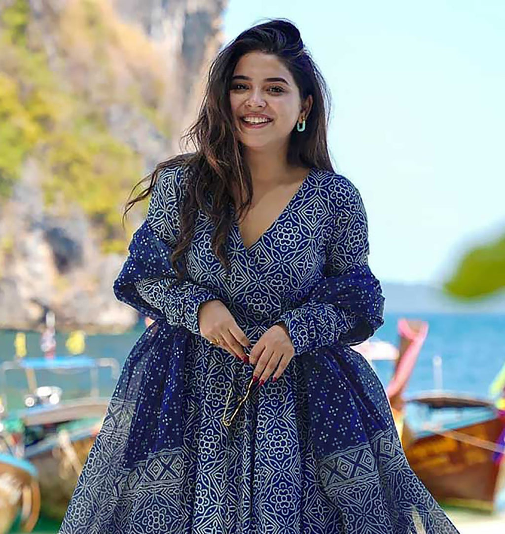 Bohemian chic indigo print anarkali suit in cotton fabric, with full sleeves and a V-neckline, paired with printed palazzo and a matching dupatta.