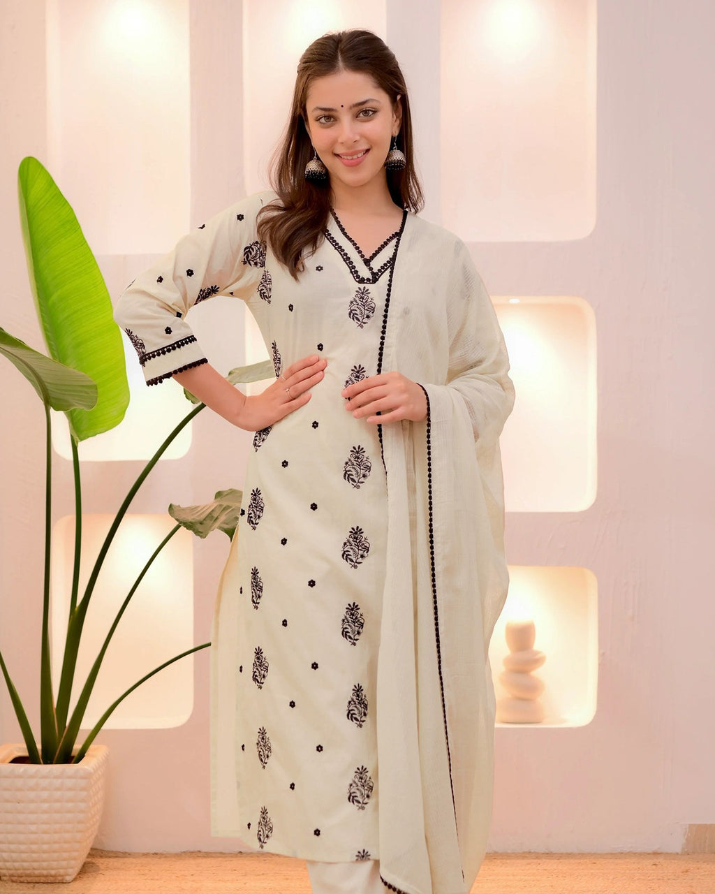Model in a casual and festive off-white kurta set with black detailing, comfortable for daily wear or small events.