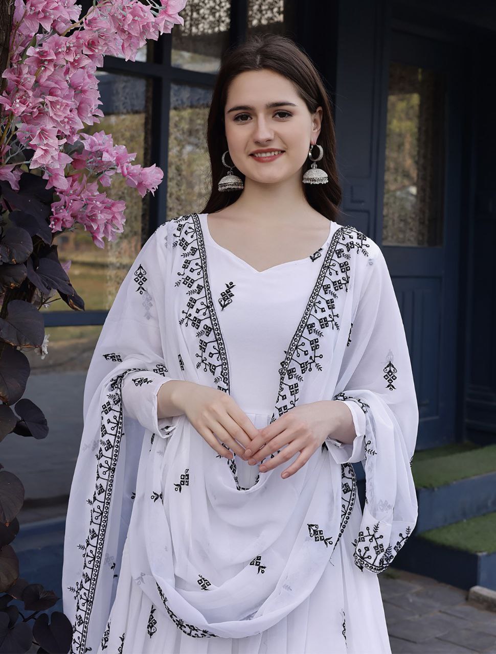 Classic white and black anarkali suit featuring a full-flared kurta with traditional black patterns and a coordinating dupatta.