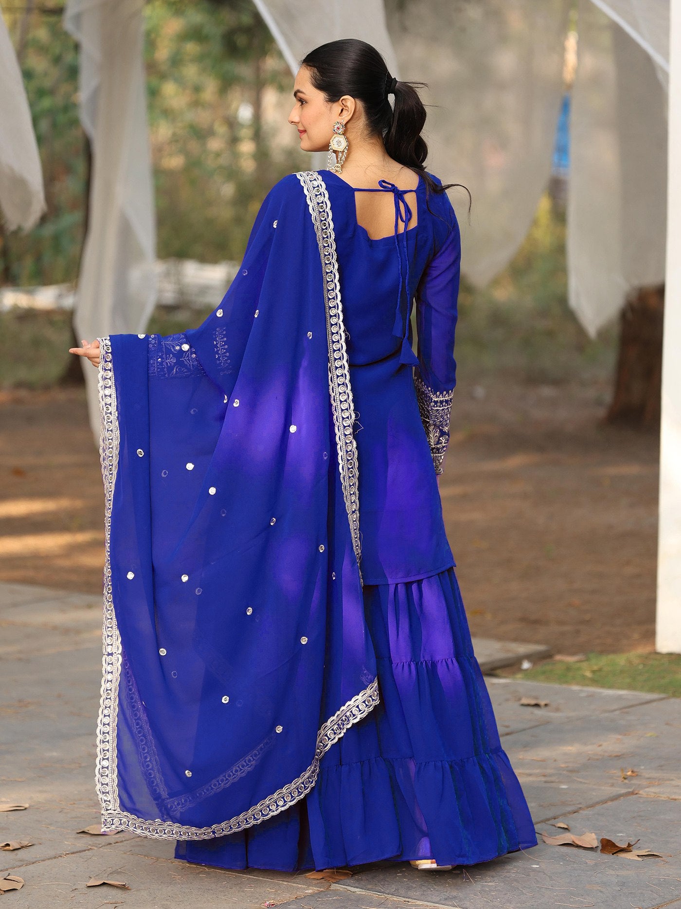 Designer party wear blue gharara set for women, featuring a georgette kurta with heavy silver embroidery and a magnificent tiered sharara.