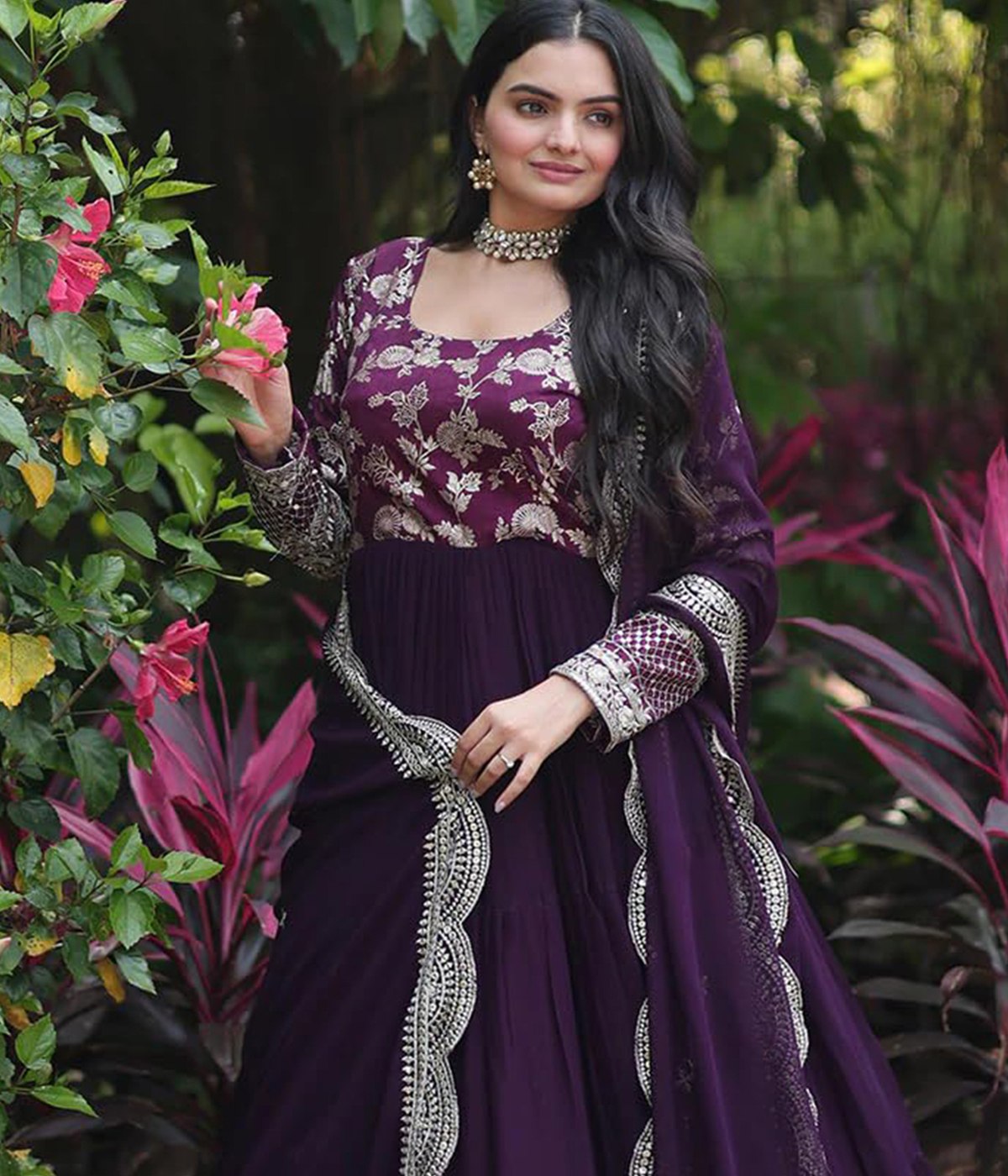 Designer plum georgette anarkali dress for women, featuring intricate gold embroidery on the bodice and a tiered, flared skirt, suitable for weddings.