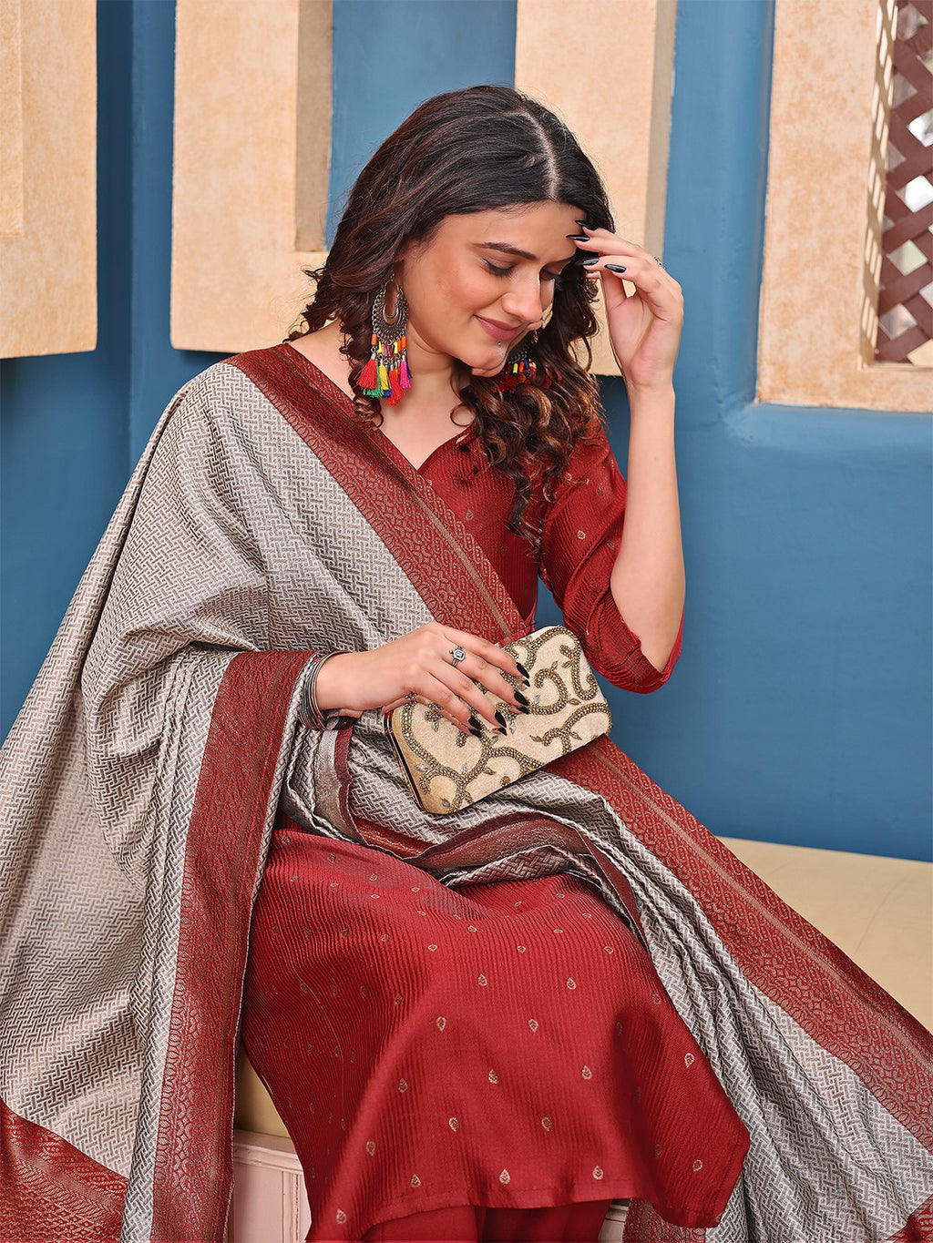 Designer rust red kurta pant set featuring subtle motifs and a luxurious silver brocade style woven dupatta with red border.