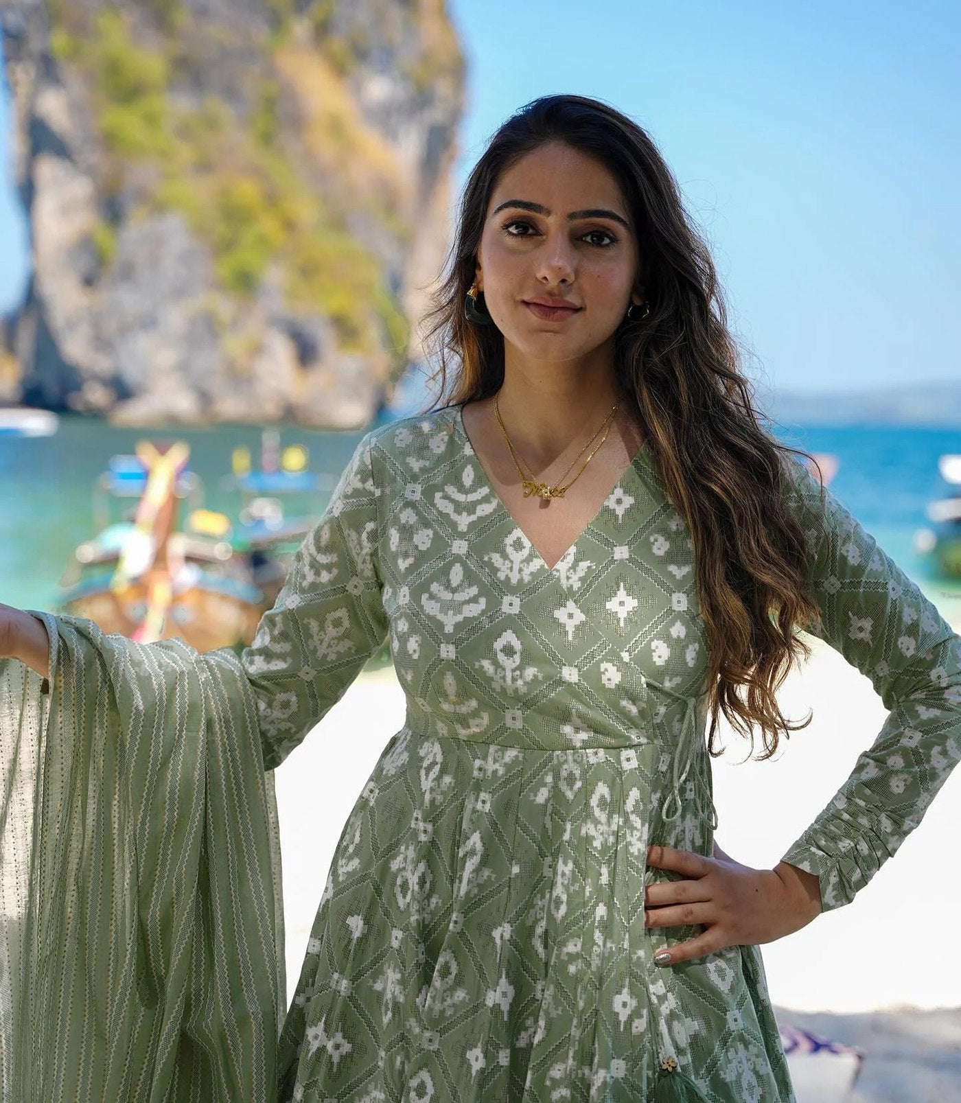 Designer summer wear green Ikkat print anarkali set for women, featuring a long flared kurta, striped palazzo, and matching dupatta.