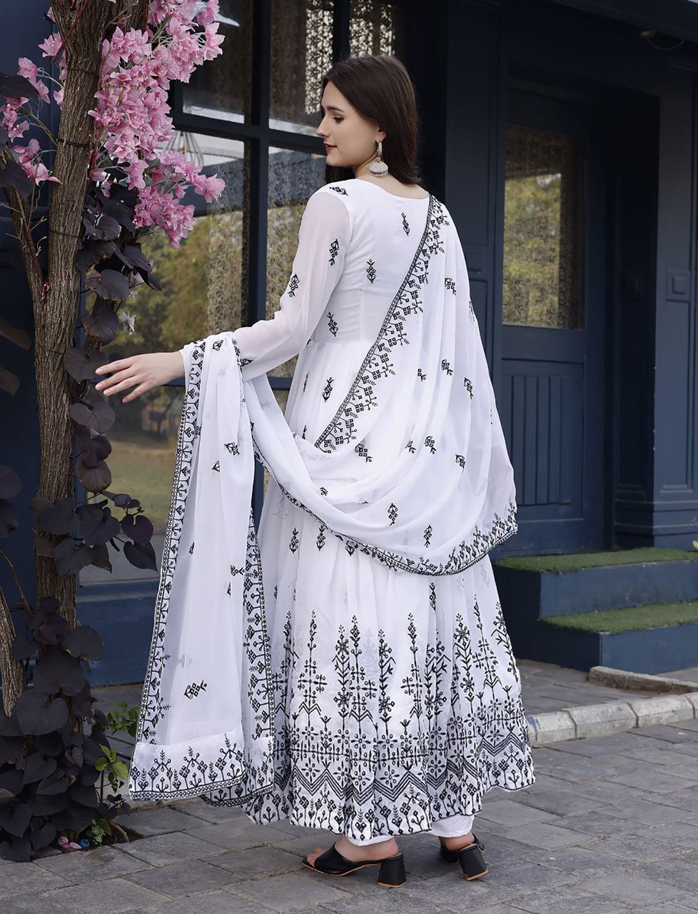 Designer white anarkali dress for women, featuring elegant black patterns on the bodice, sleeves, and flared hem, with a dupatta.
