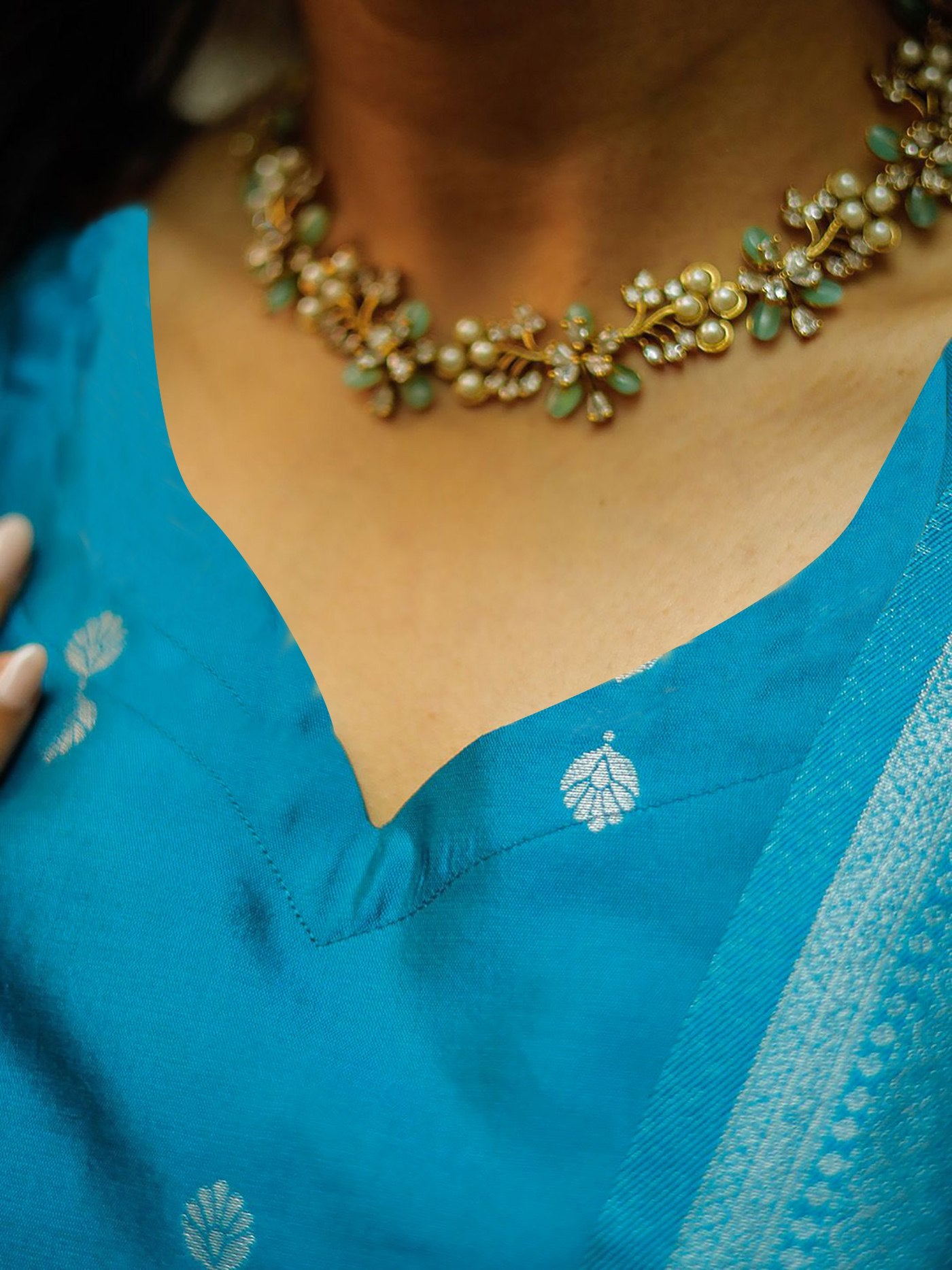 legant aqua blue chanderi silk suit with a plain kurta and a rich, heavily woven cream and blue contrast dupatta, styled with gold sandals.