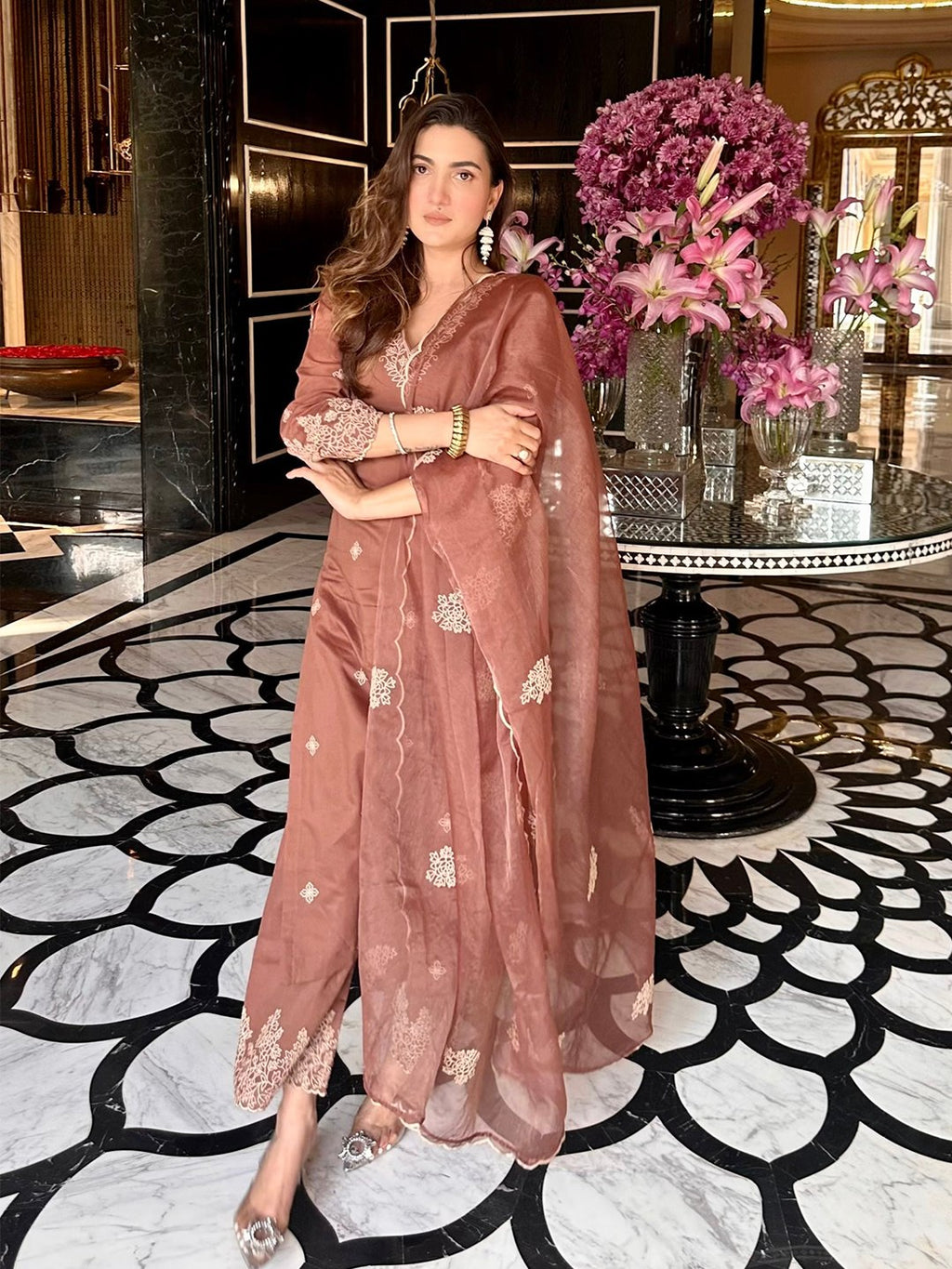 Elegant brown kurta set with stylish bell sleeves adorned with embroidery, straight pants, and a sheer dupatta.
