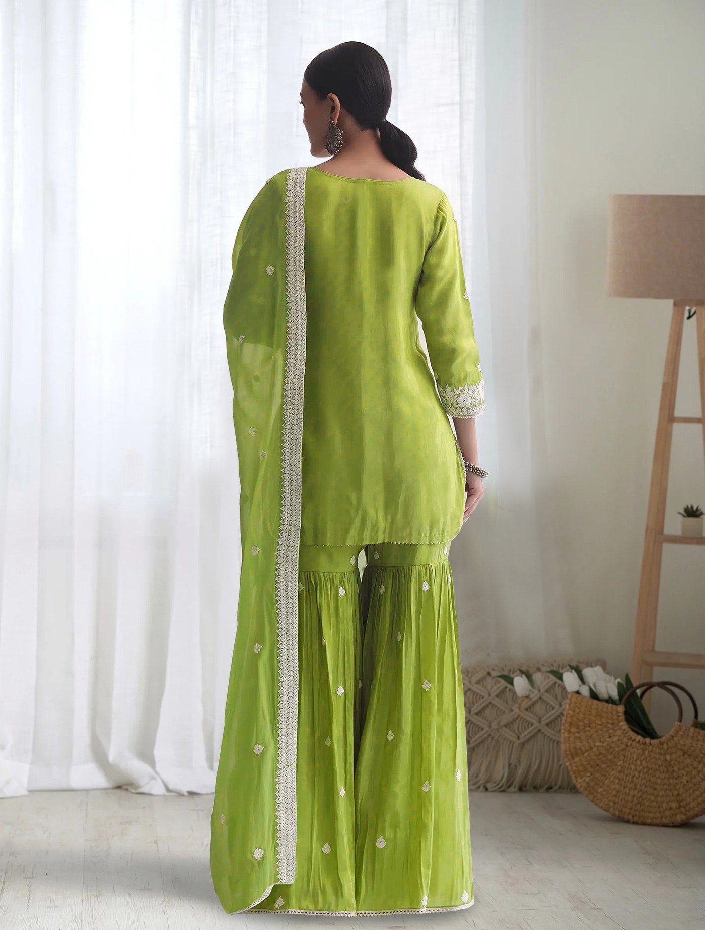 Elegant lime green sharara with Chikankari style white embroidery on the round neck kurta, ideal for festive and party wear.
