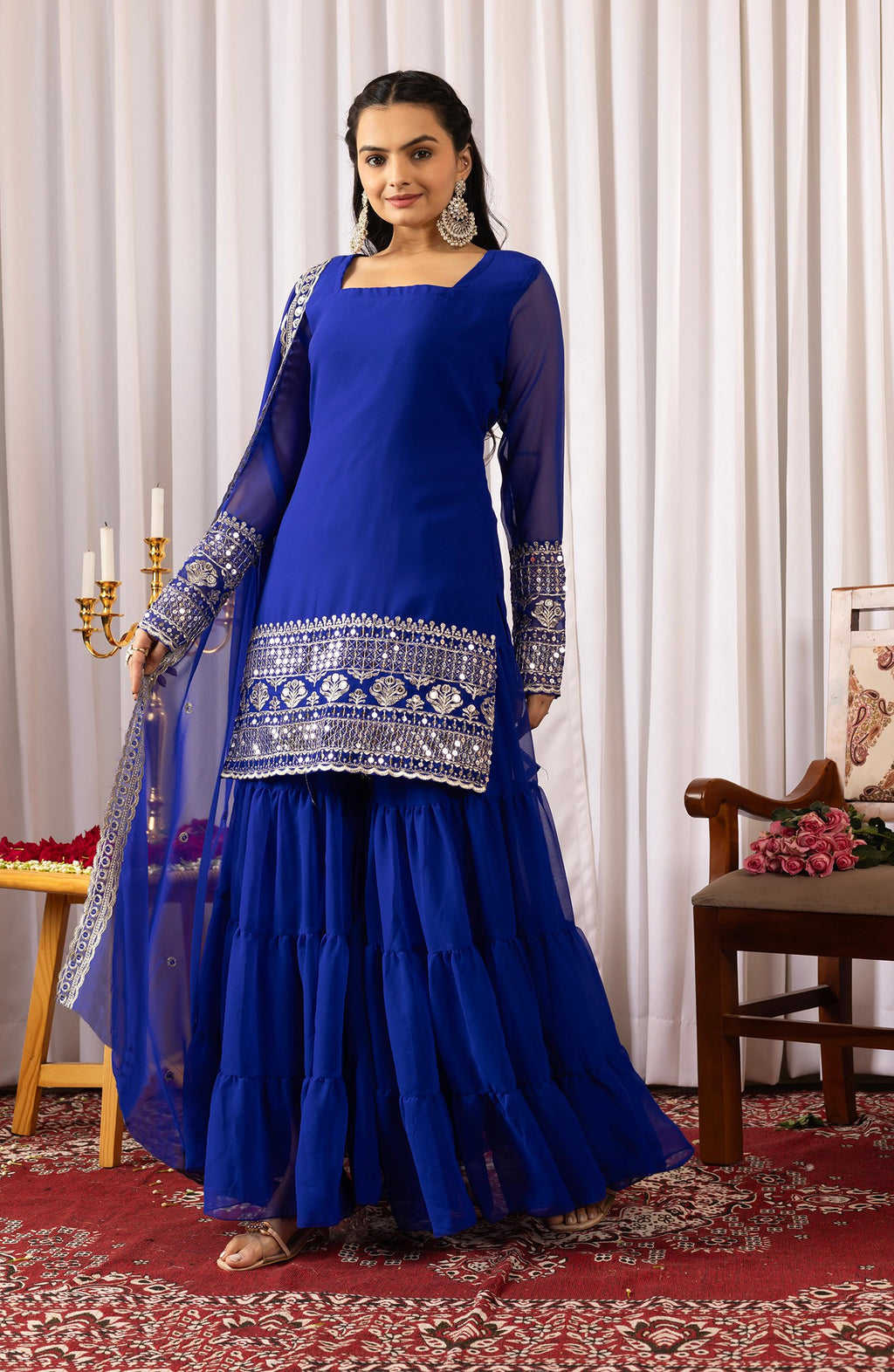 Elegant indigo blue sharara suit with intricate silver zari and mirror work on the kurta and sleeves, paired with a matching tiered sharara.