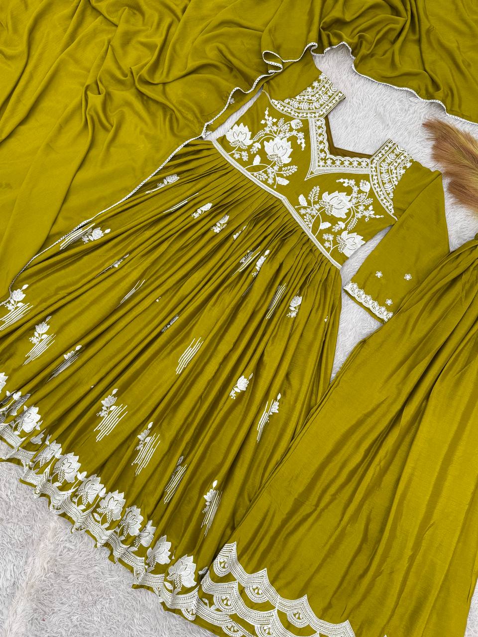 Elegant khaki green Anarkali dress with intricate white floral thread embroidery on the bodice, sleeves, and hem, paired with embroidered palazzo pants.