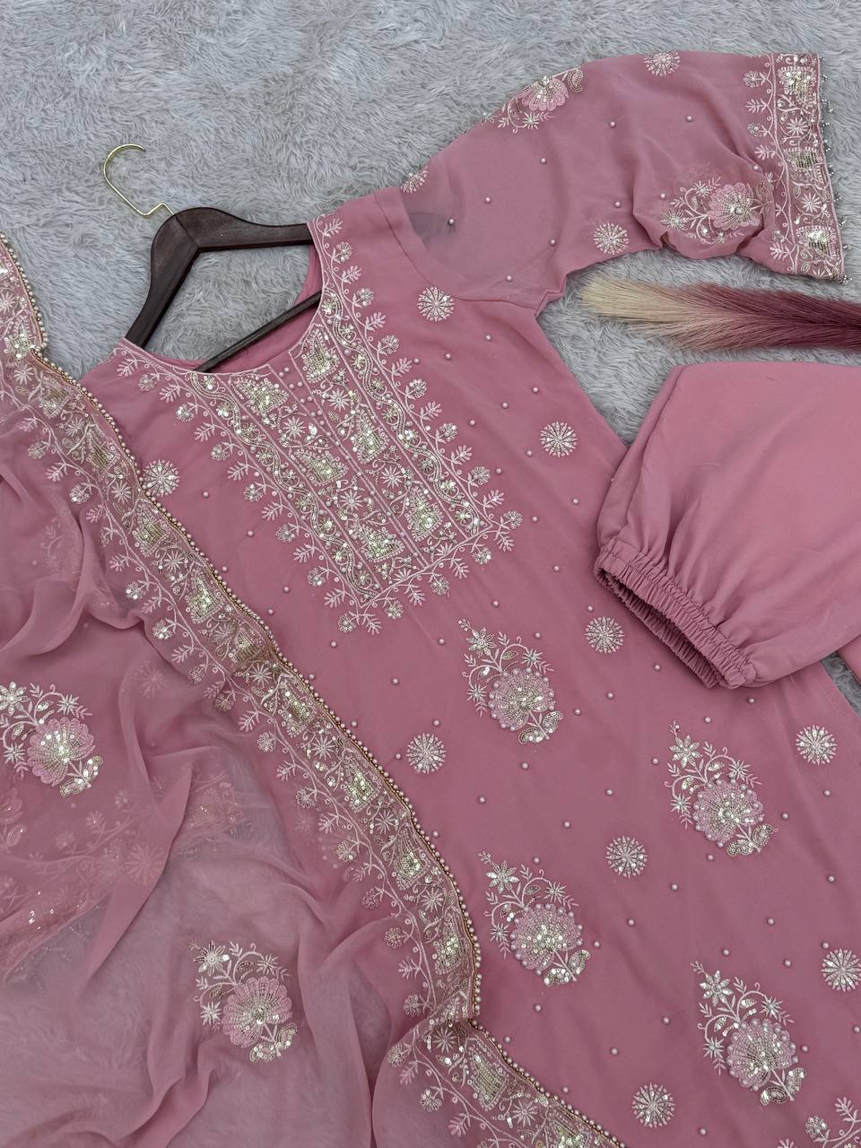 Elegant rose pink ethnic suit with intricate white thread embroidery on the kurta, stylish bell sleeves, and matching broad palazzo pants.