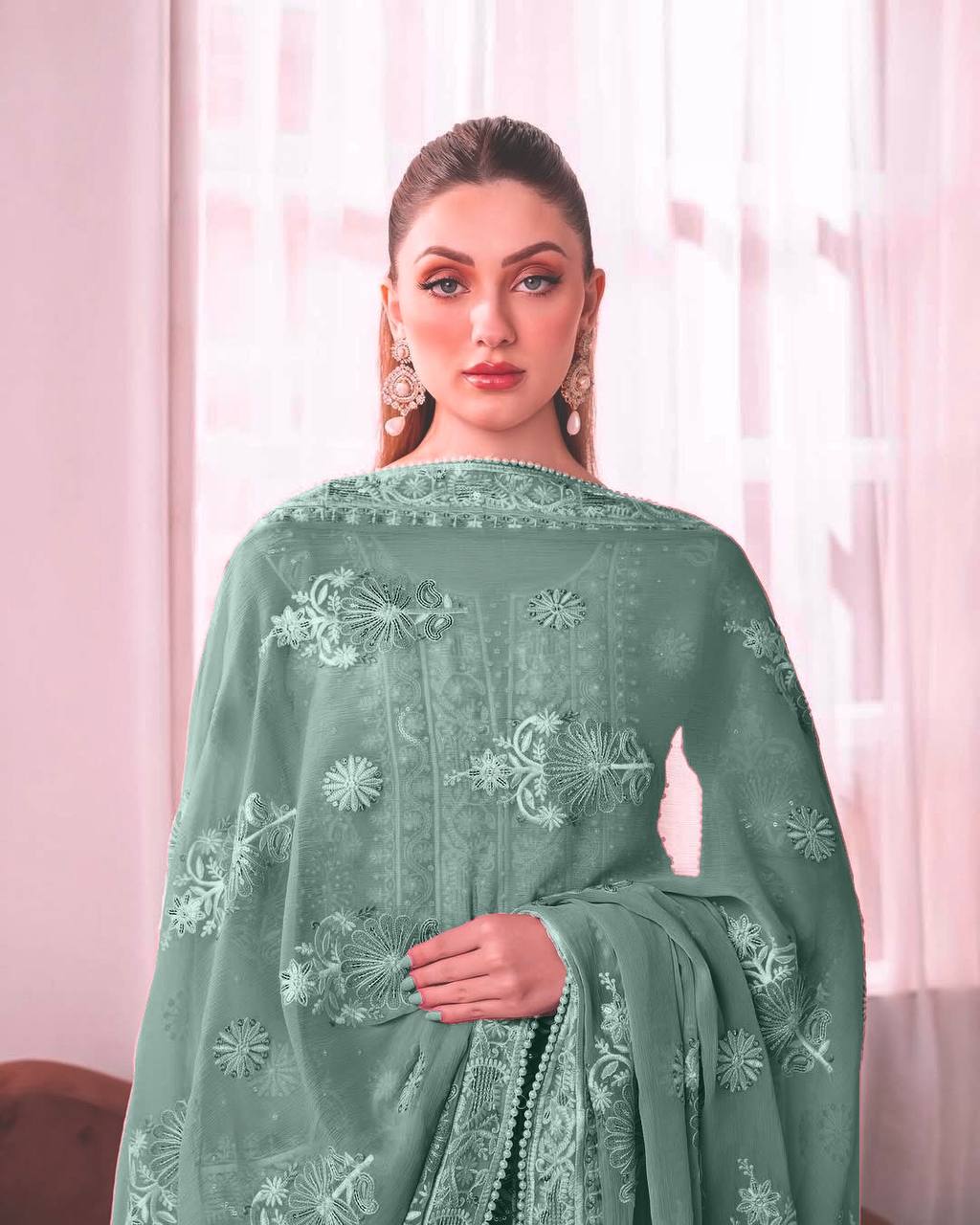 Elegant sage green ethnic suit with intricate white thread embroidery on the kurta, stylish bell sleeves, and matching broad palazzo pants.