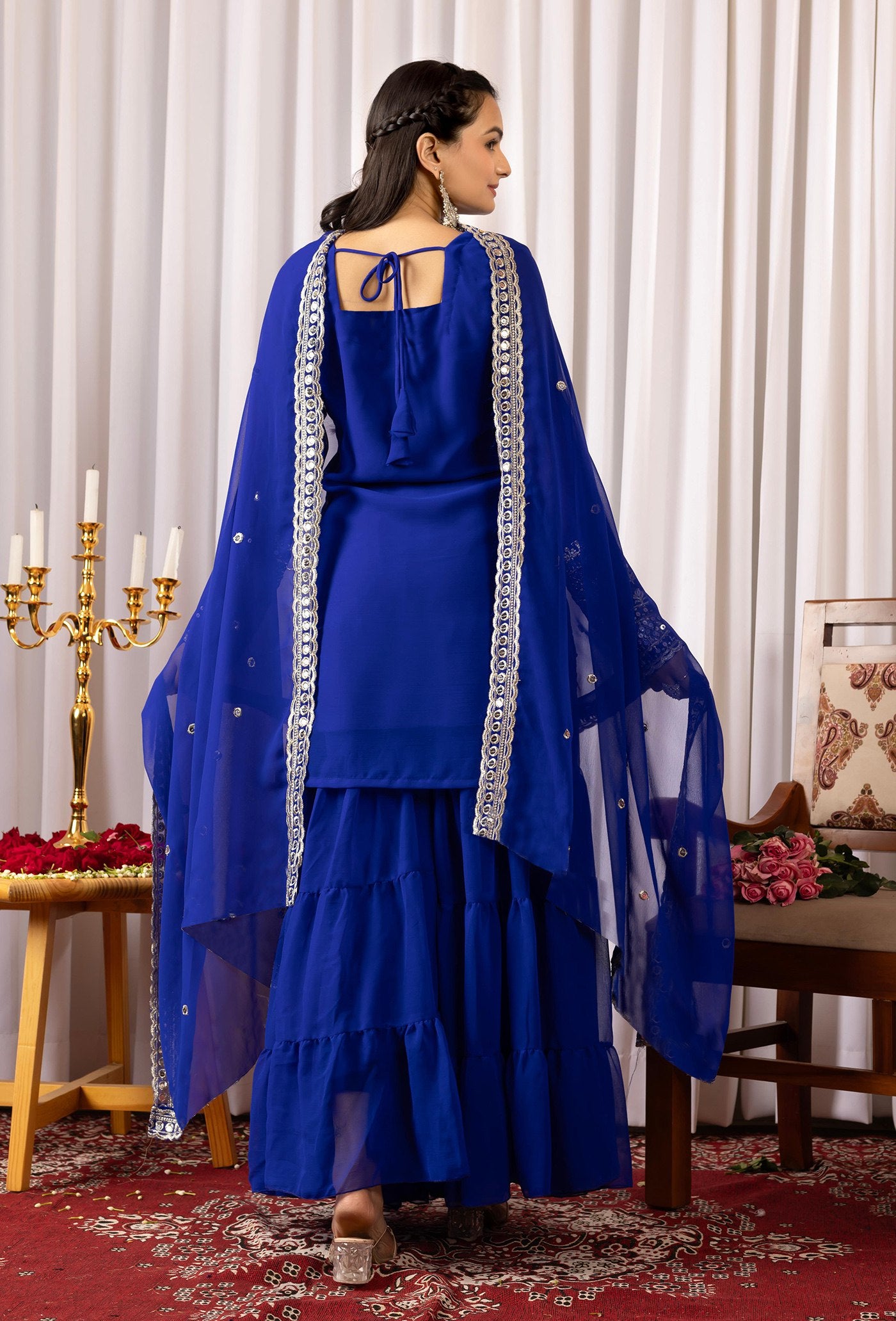 Embroidered cobalt blue sharara suit with a square neck kurta, full sleeves with heavy cuffs, and a layered flared sharara.