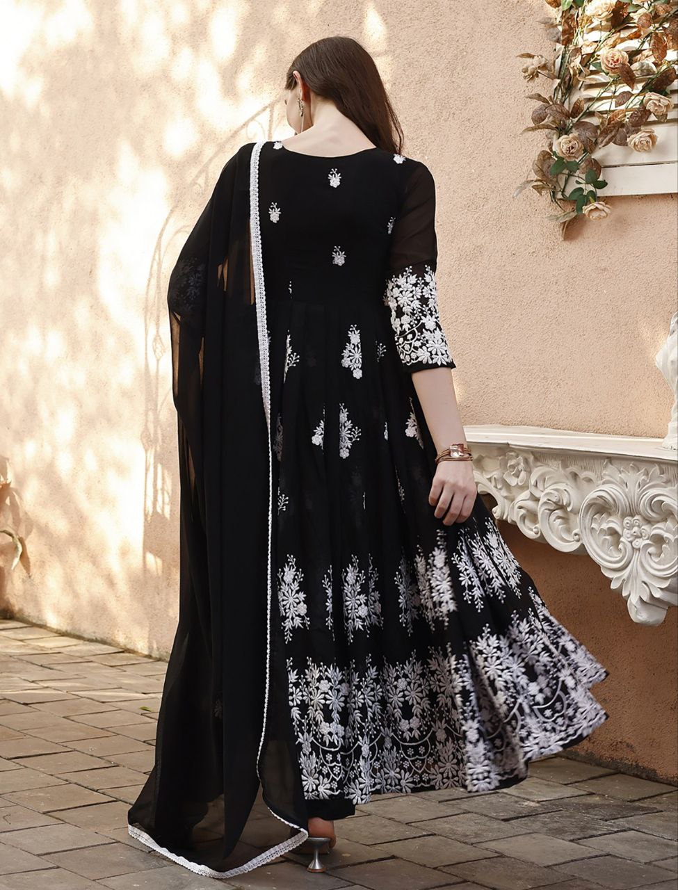 Indian ethnic wear: black anarkali with white thread embroidery on bodice, sleeves, and hem, with dupatta.