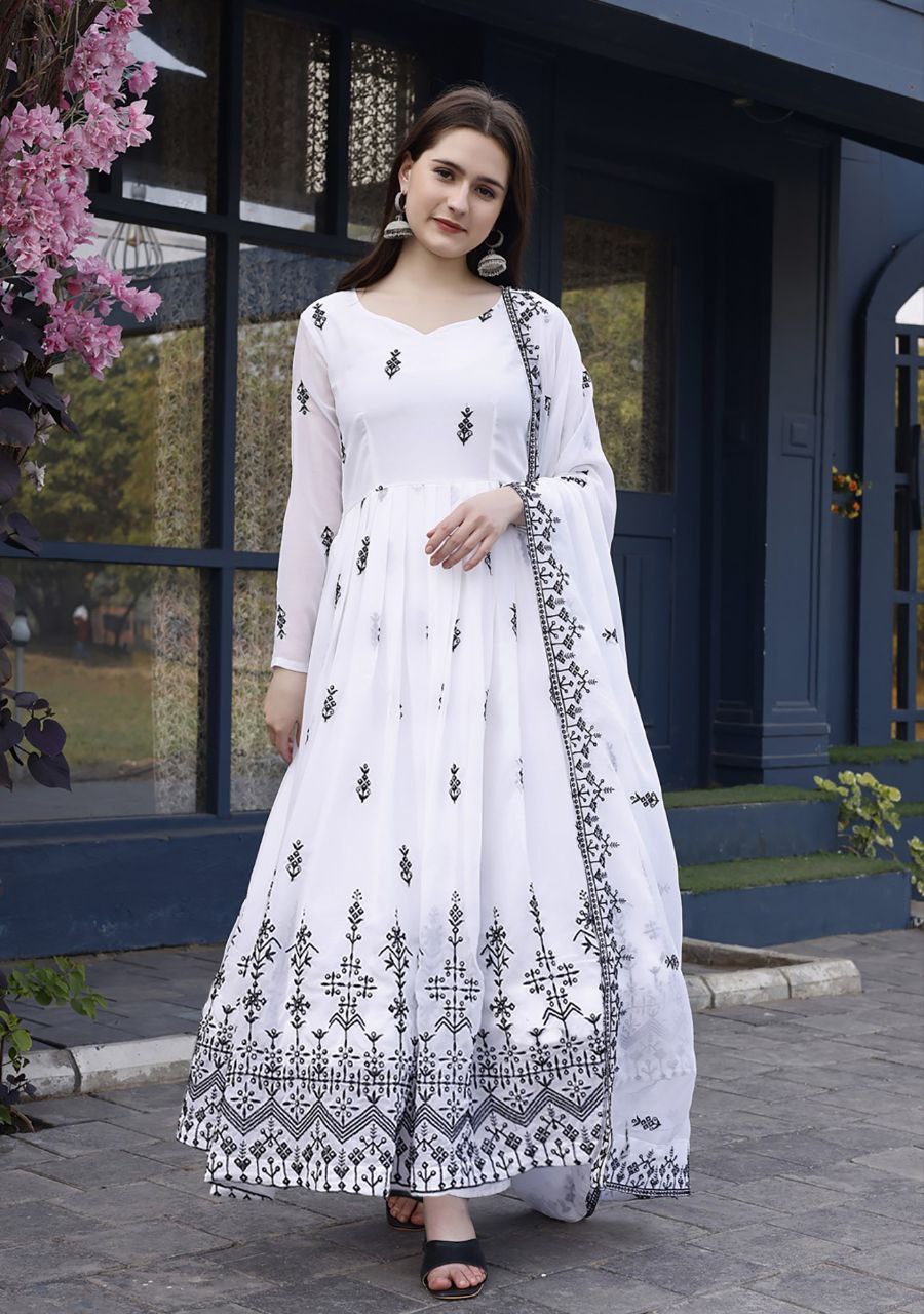 Ethnic white anarkali with geometric black print/embroidery on the border and sleeves, paired with a white dupatta.