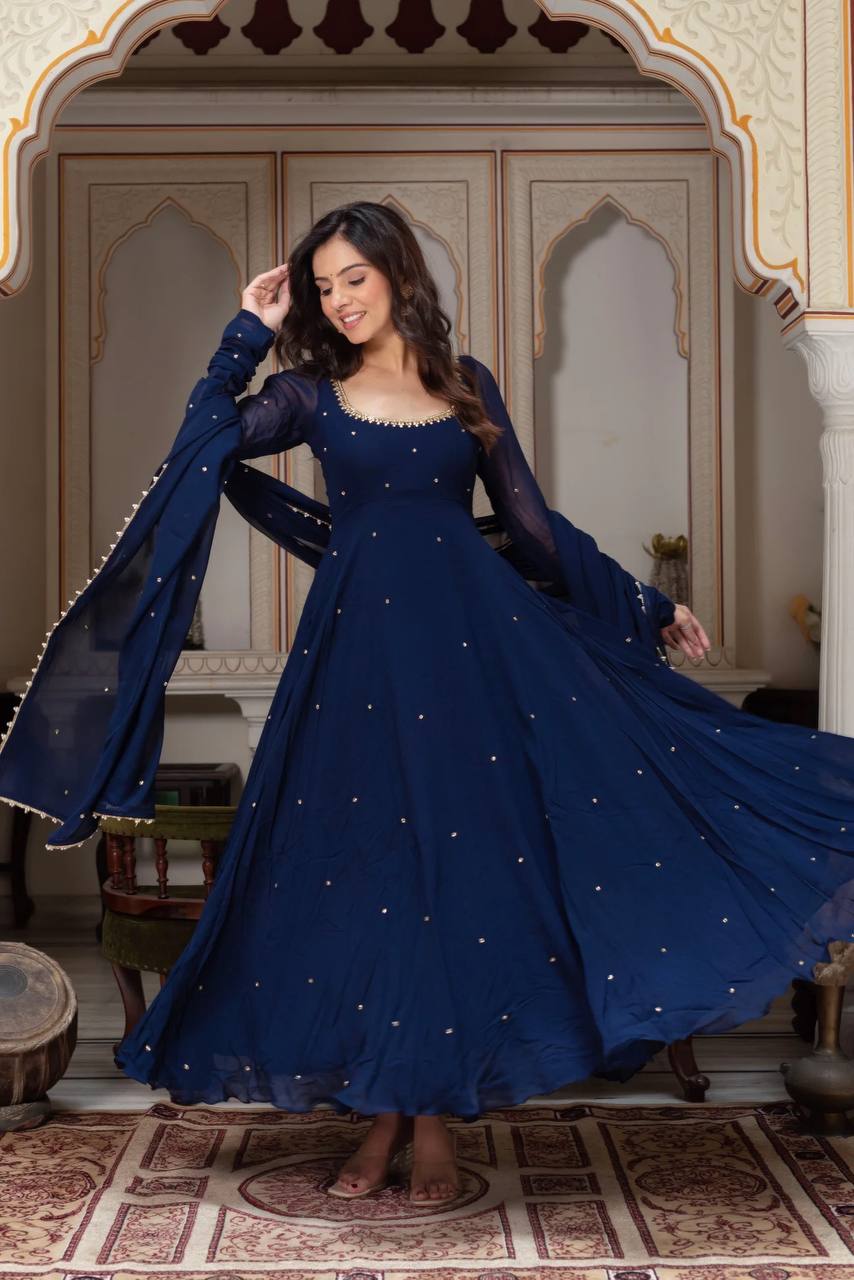 Model in an evening special navy blue anarkali gown with gold Gota Patti detailing on the neckline and dupatta, showcasing a timeless and graceful look.