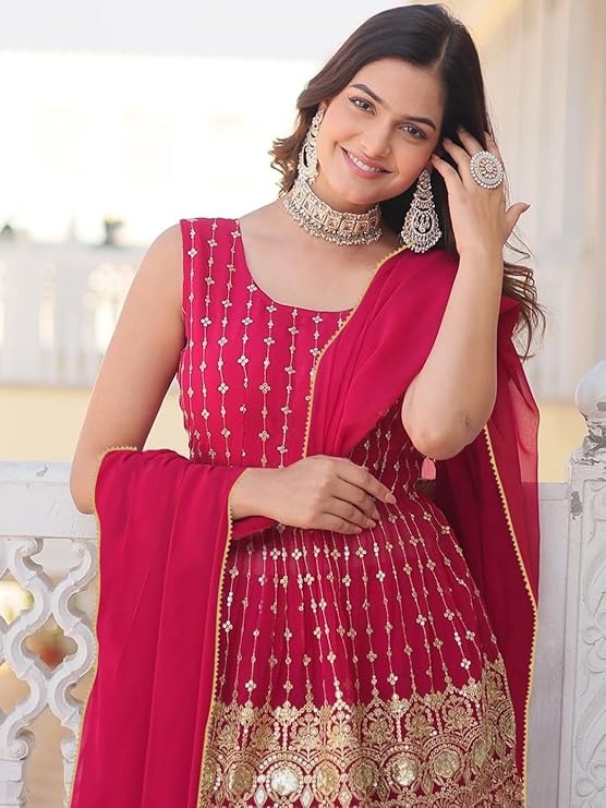Model in a festive magenta short kurta gharara set, perfect for Sangeet and Mehendi functions, with dazzling gold embellishments.
