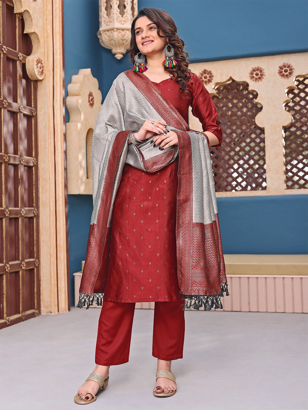 Model in a festive maroon and grey Punjabi suit, perfect for celebrations and traditional events.
