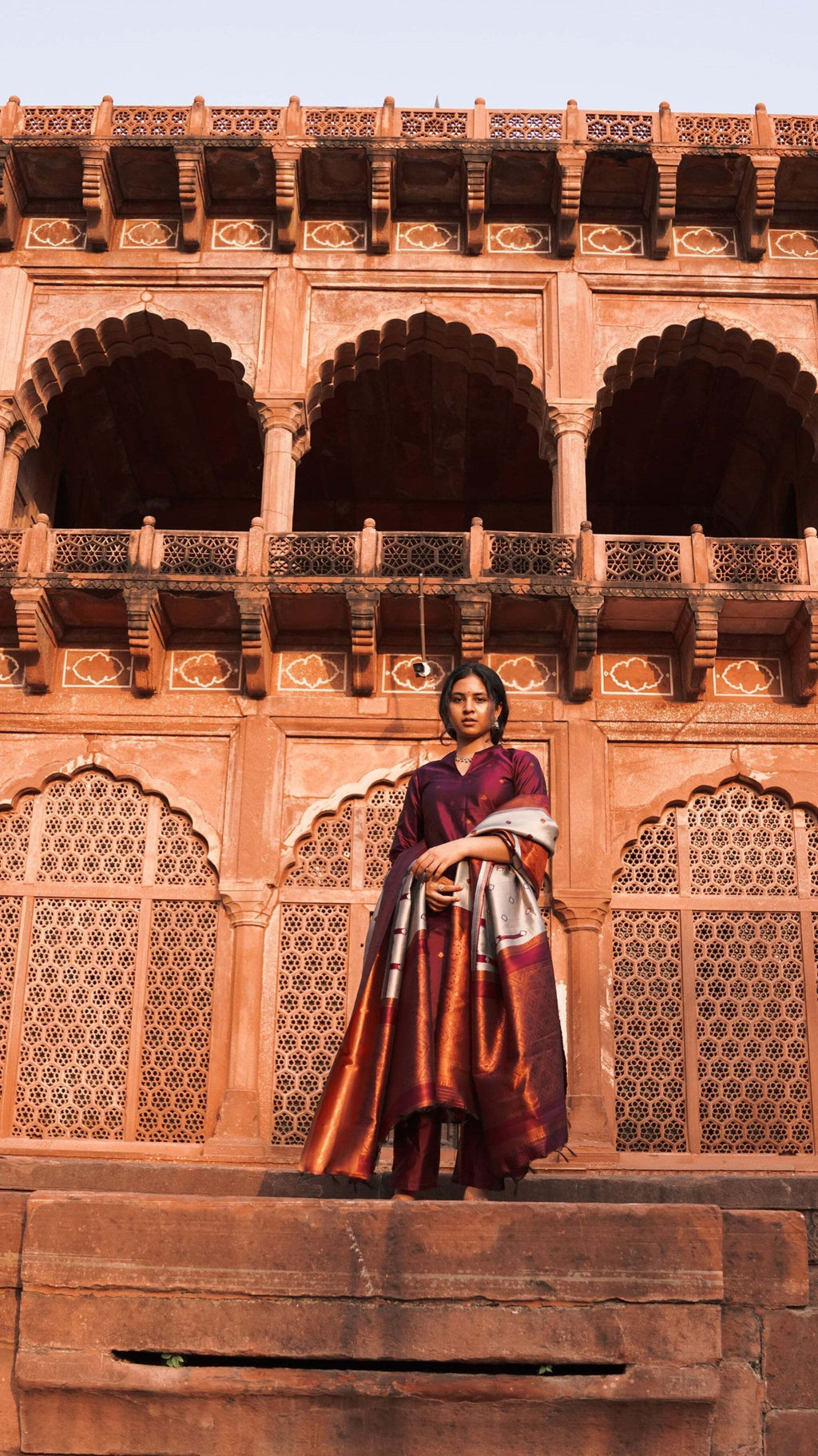 Model in a festive plum kurta pant dupatta set, perfect for celebrations and traditional events.
