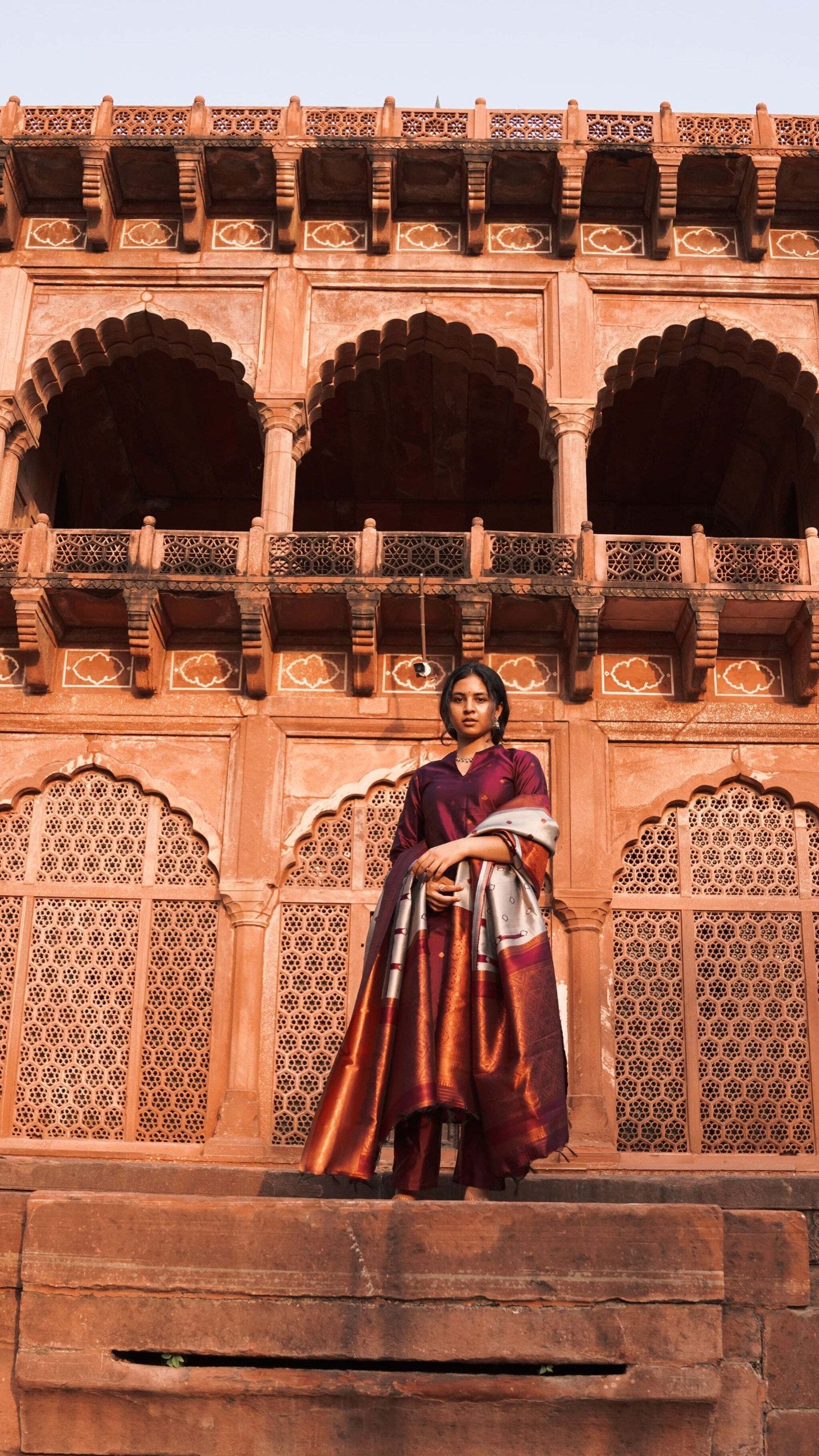 Model in a festive plum kurta pant dupatta set, perfect for celebrations and traditional events.
