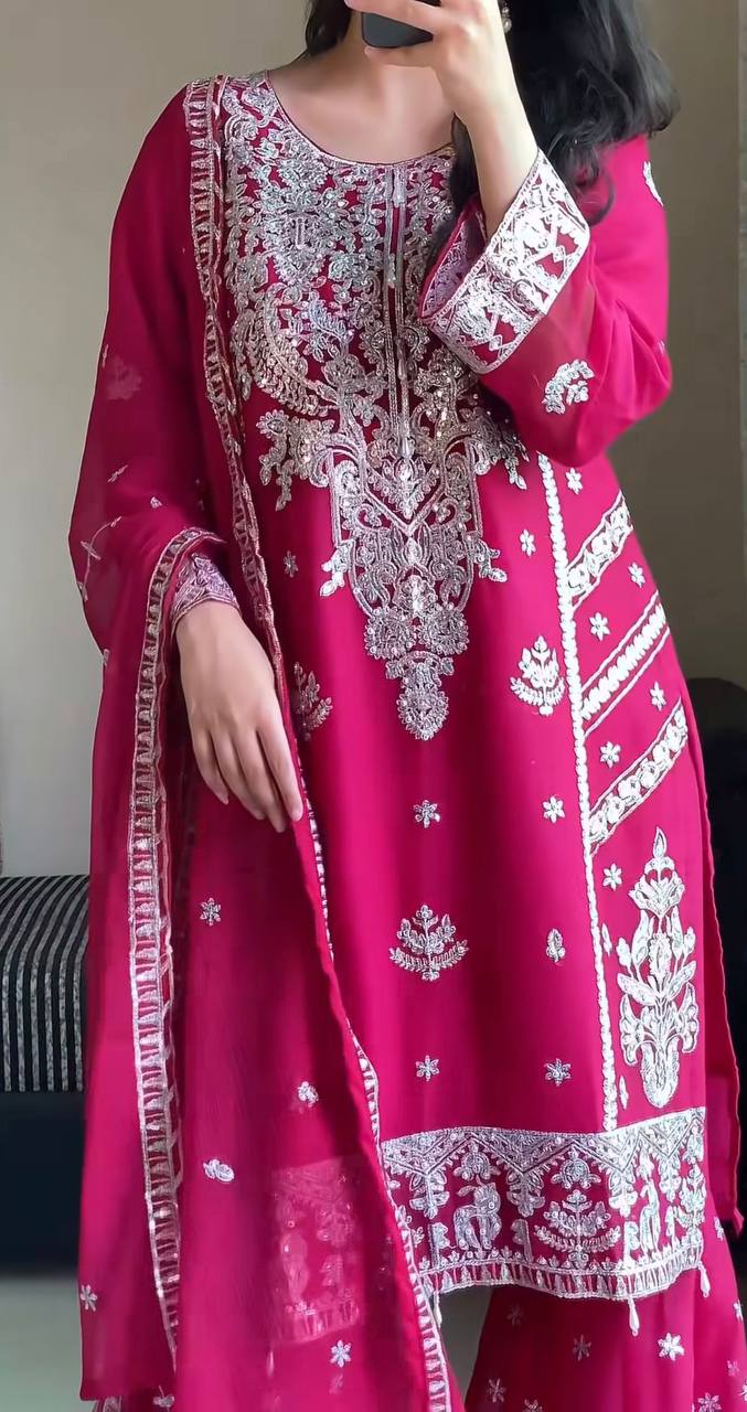 Glamorous magenta gharara set for women, with a heavily embroidered kurta, tiered gharara, and a matching sheer organza dupatta with silver borders.