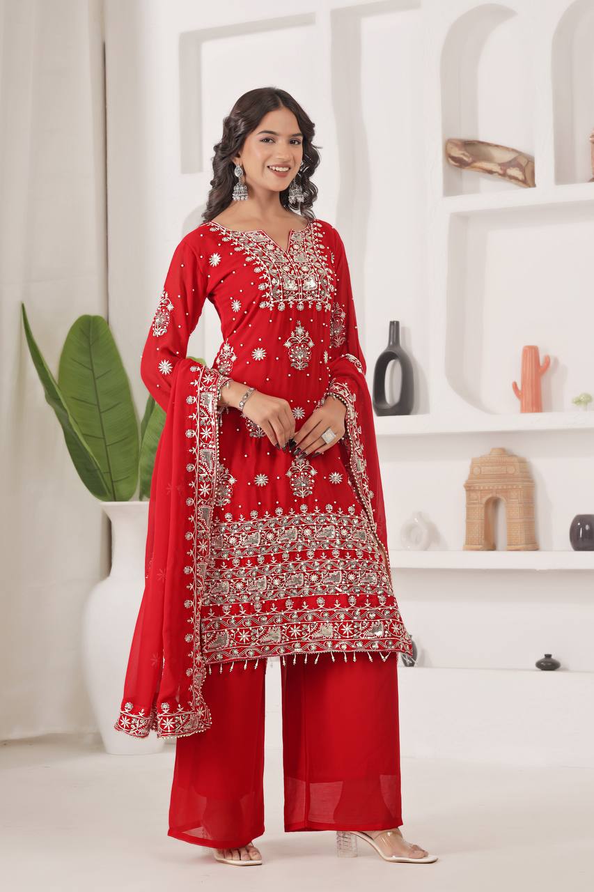 Model in glamorous red ethnic wear, a straight kurta adorned with silver gota patti and sequin detailing, paired with broad palazzo and an embellished dupatta.