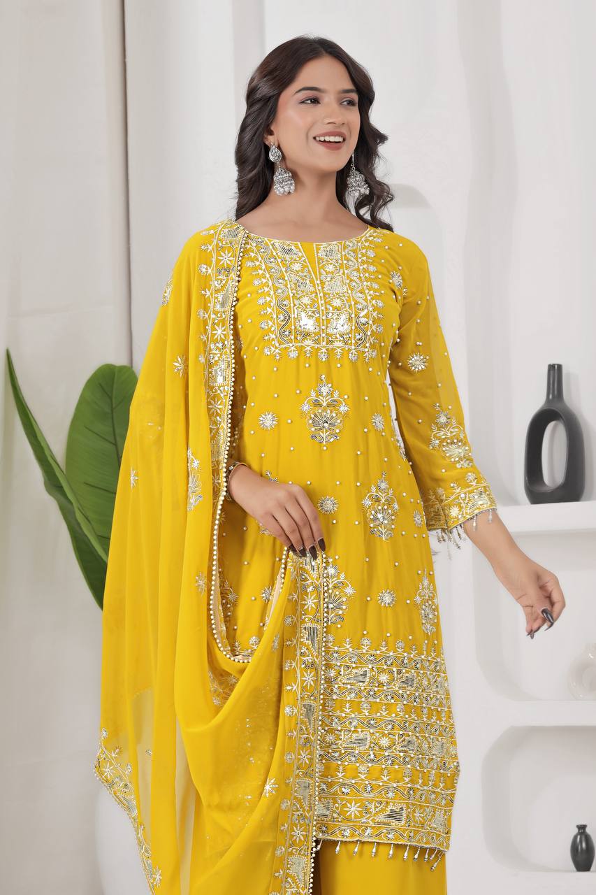 Lalily.in's yellow ethnic palazzo suit, featuring a heavily embroidered georgette kurta with silver work, broad palazzo pants, and a matching dupatta.