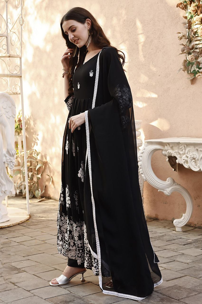 Full length view of a black anarkali dress for women with a wide flare and beautiful white embroidery.
