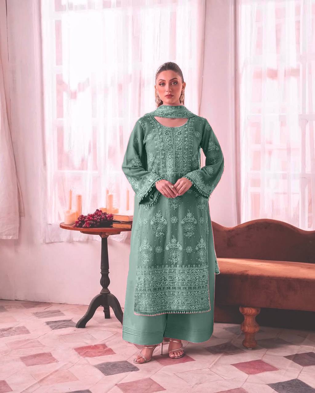 Woman wearing a mint green straight-cut kurta with intricate white thread embroidery, bell sleeves, broad palazzo pants, and a matching dupatta.