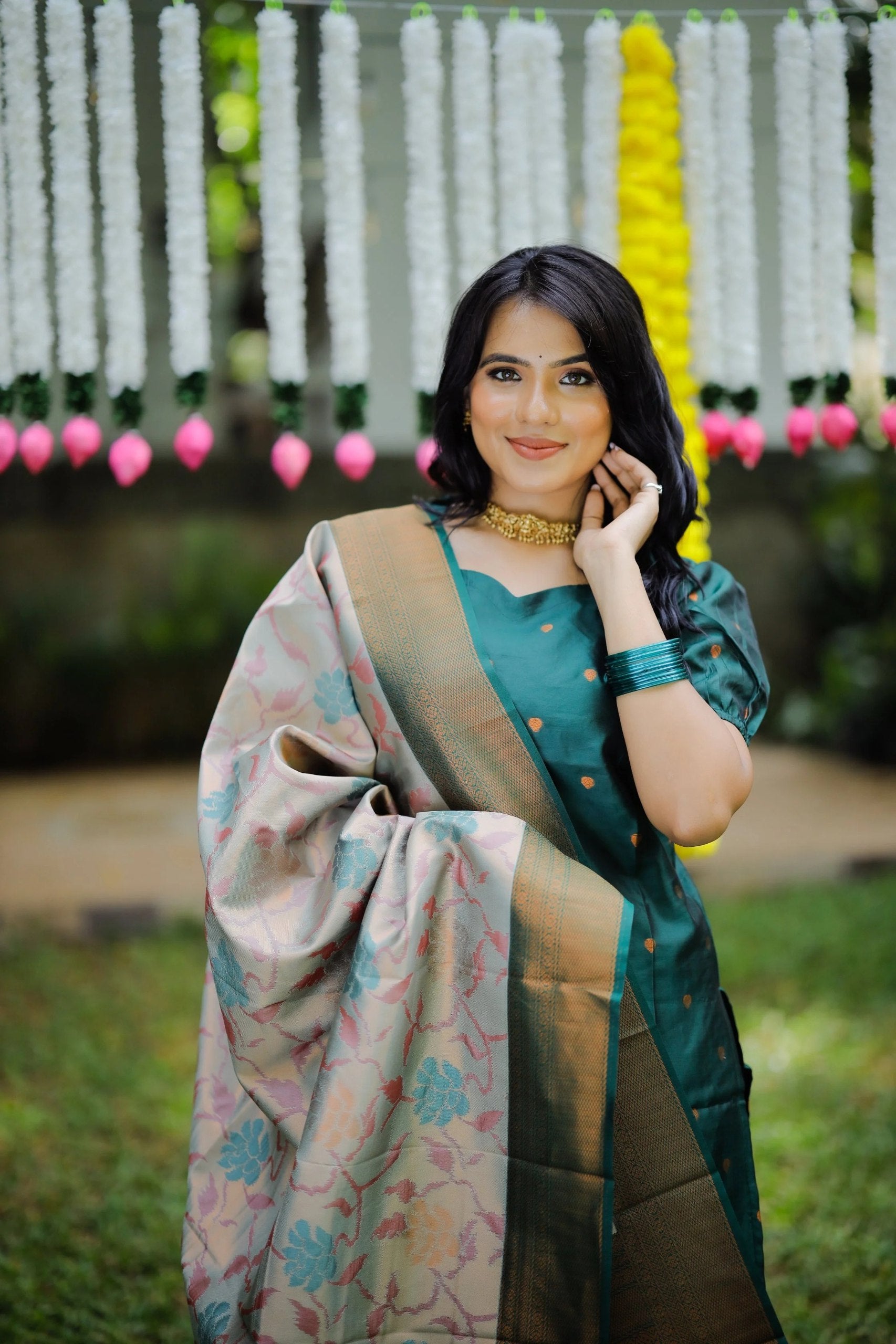 Woman wearing a puff sleeve green kurta with palazzo, accessorized with a gold choker and a Banarasi dupatta.