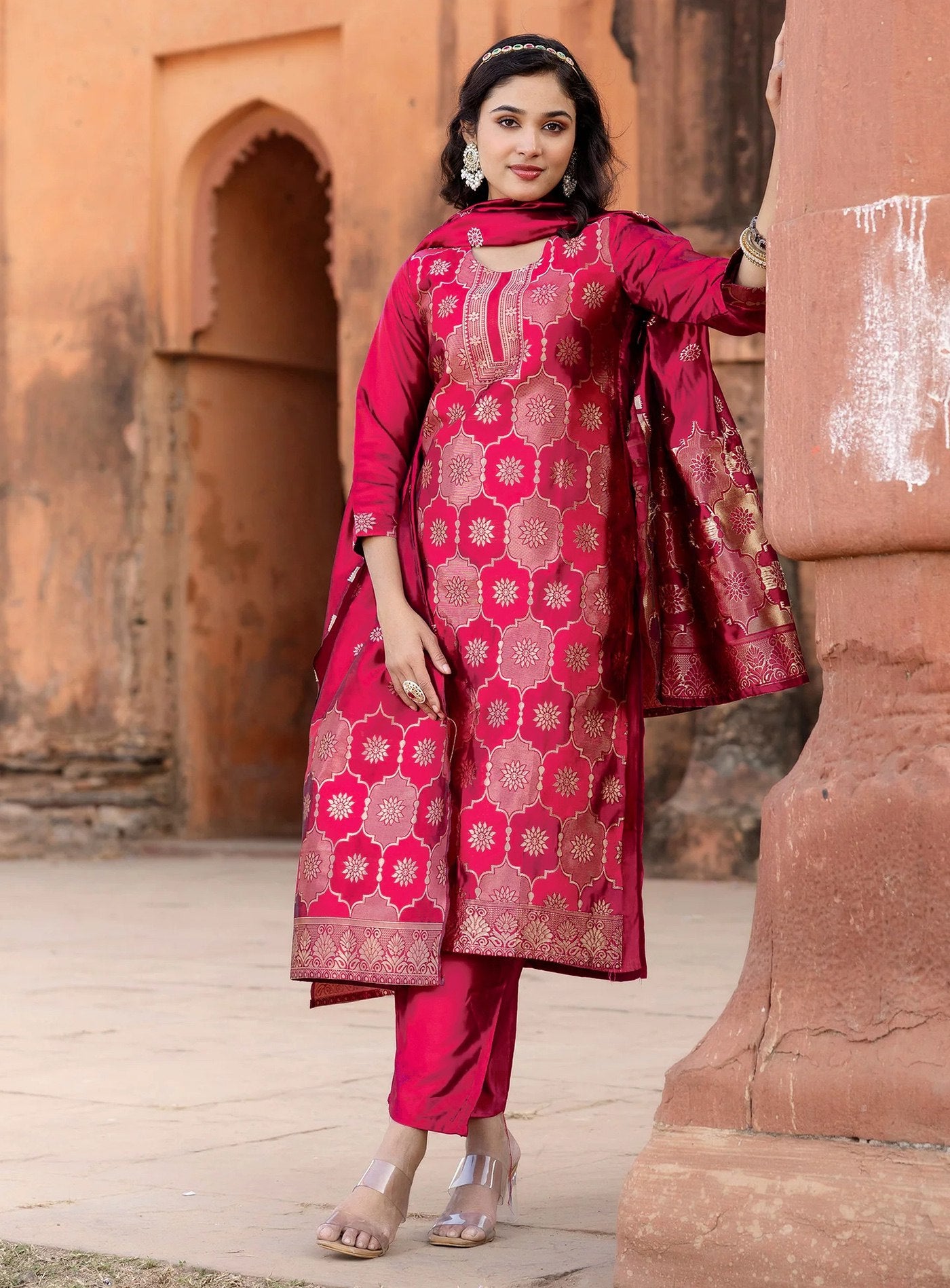 oman wearing a vibrant rani pink silk blend kurta set with gold Banarasi brocade weaving on the kurta and dupatta, paired with matching straight pants.