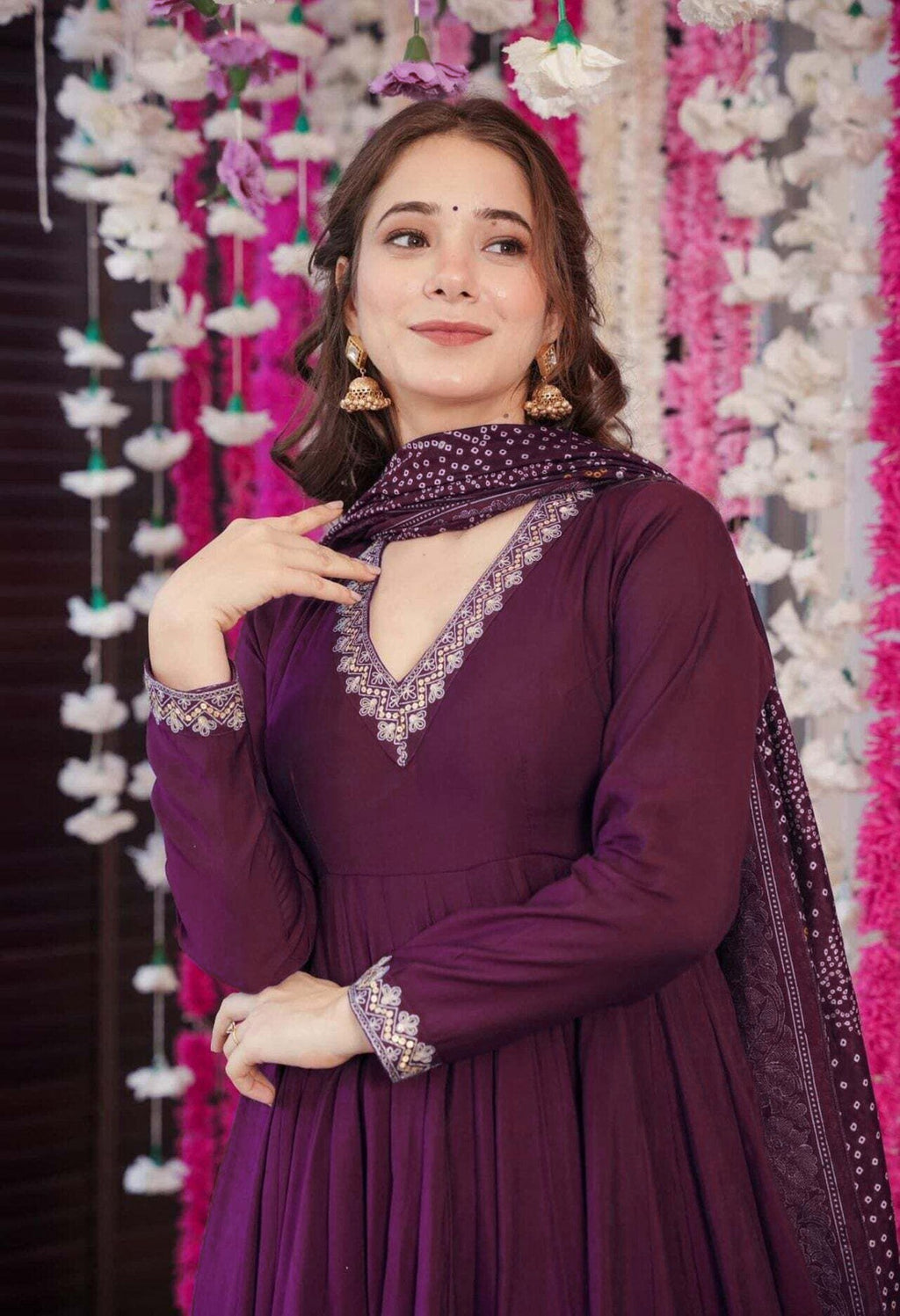 Readymade violet anarkali kurta set with a flared design, full sleeves, and a colorful Bandhani print dupatta, suitable for cultural events.