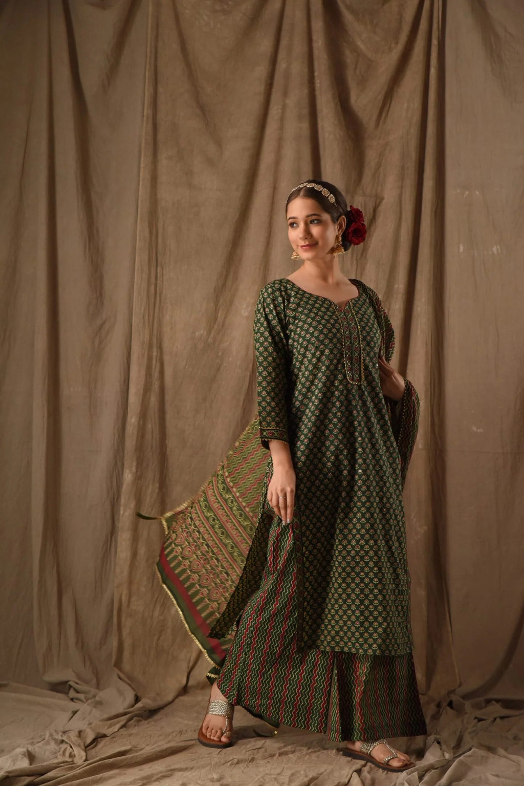 Traditional Jaipuri style print anarkali set in dark green with red and beige motifs, paired with a matching dupatta.