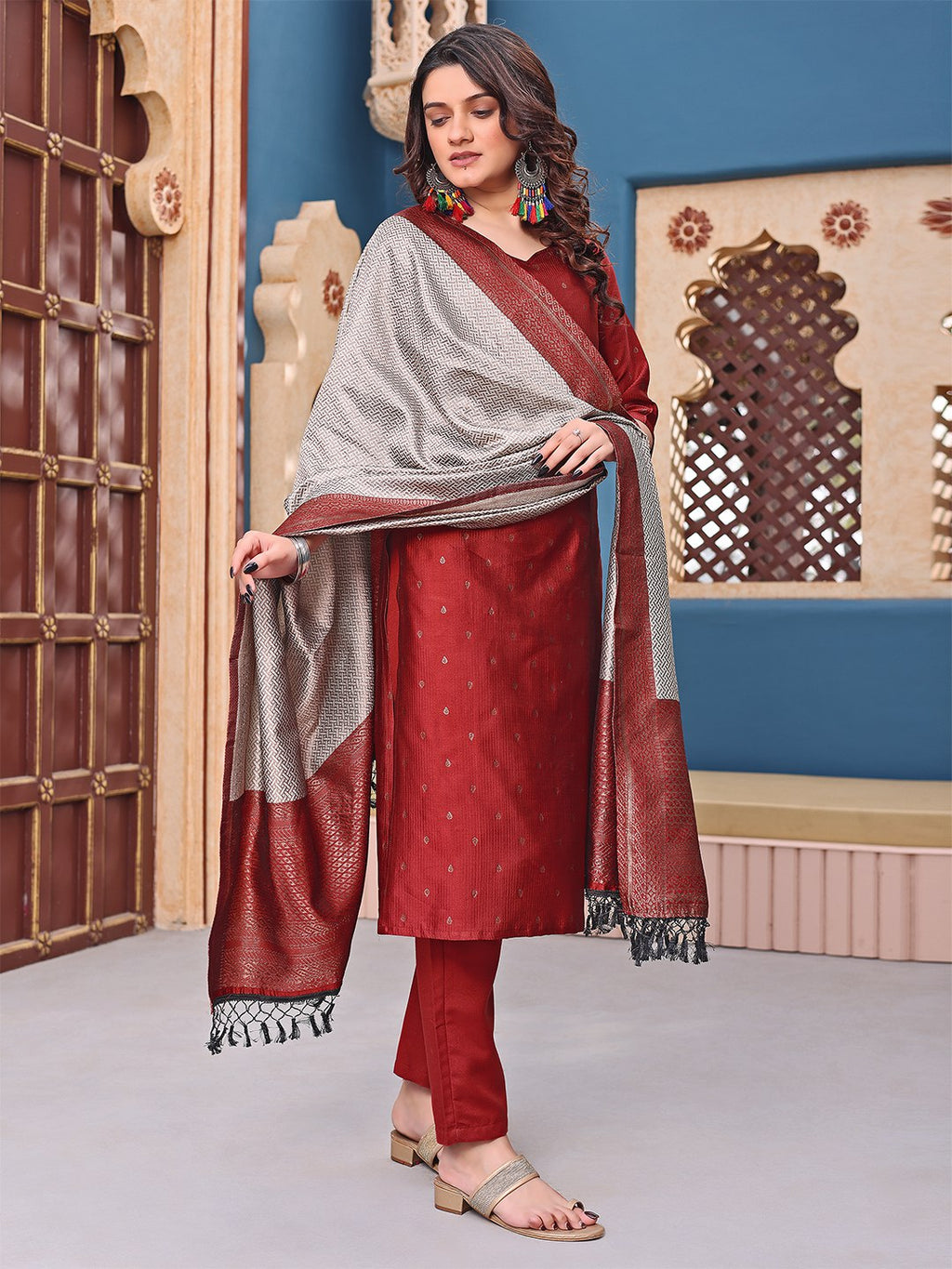 Traditional maroon ethnic suit with straight cut kurta and pants, paired with a unique silver woven dupatta.