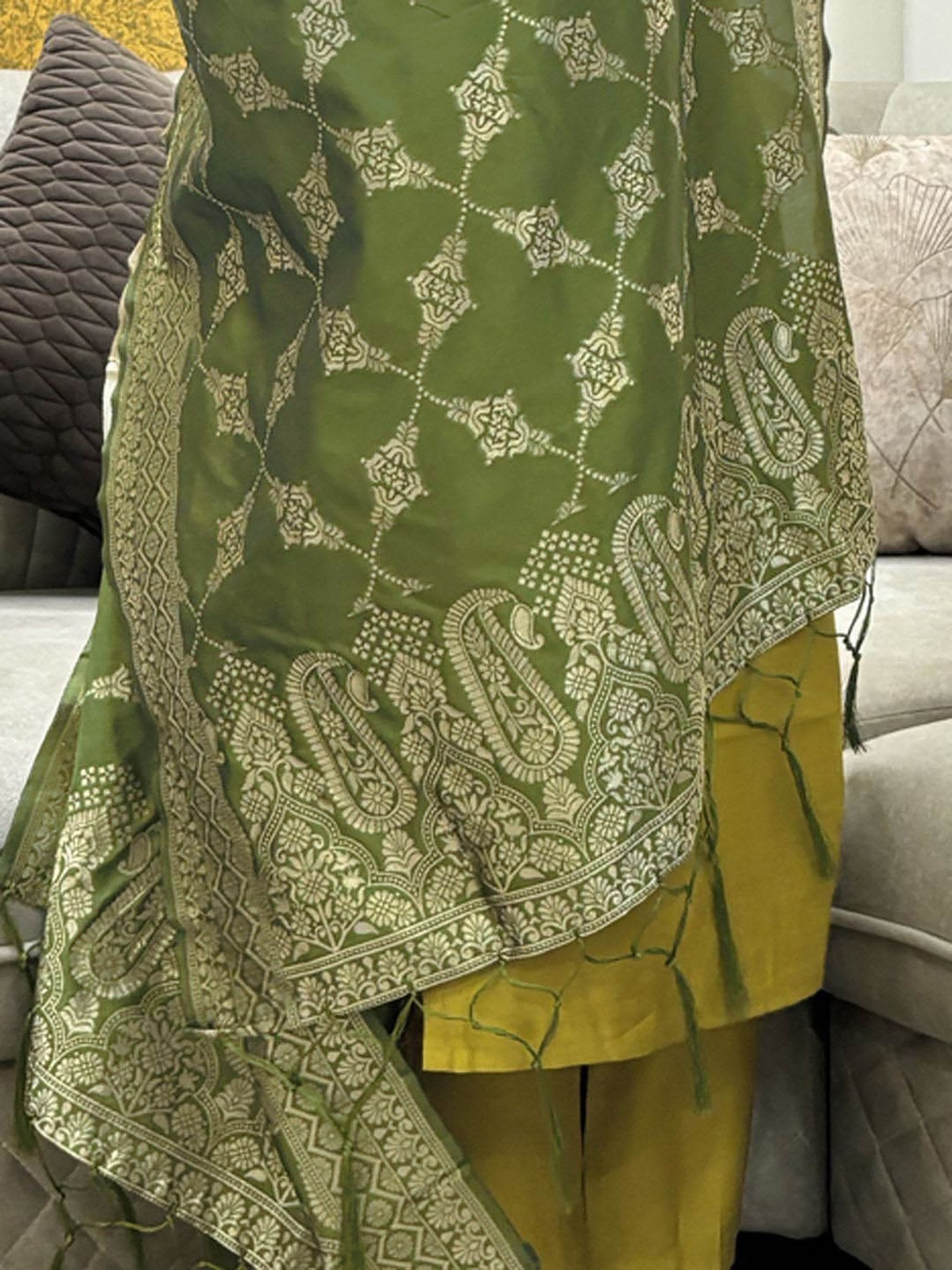 Traditional mustard yellow kurta with an embroidered yoke, matching straight pants, and a luxurious bottle green Banarasi dupatta.
