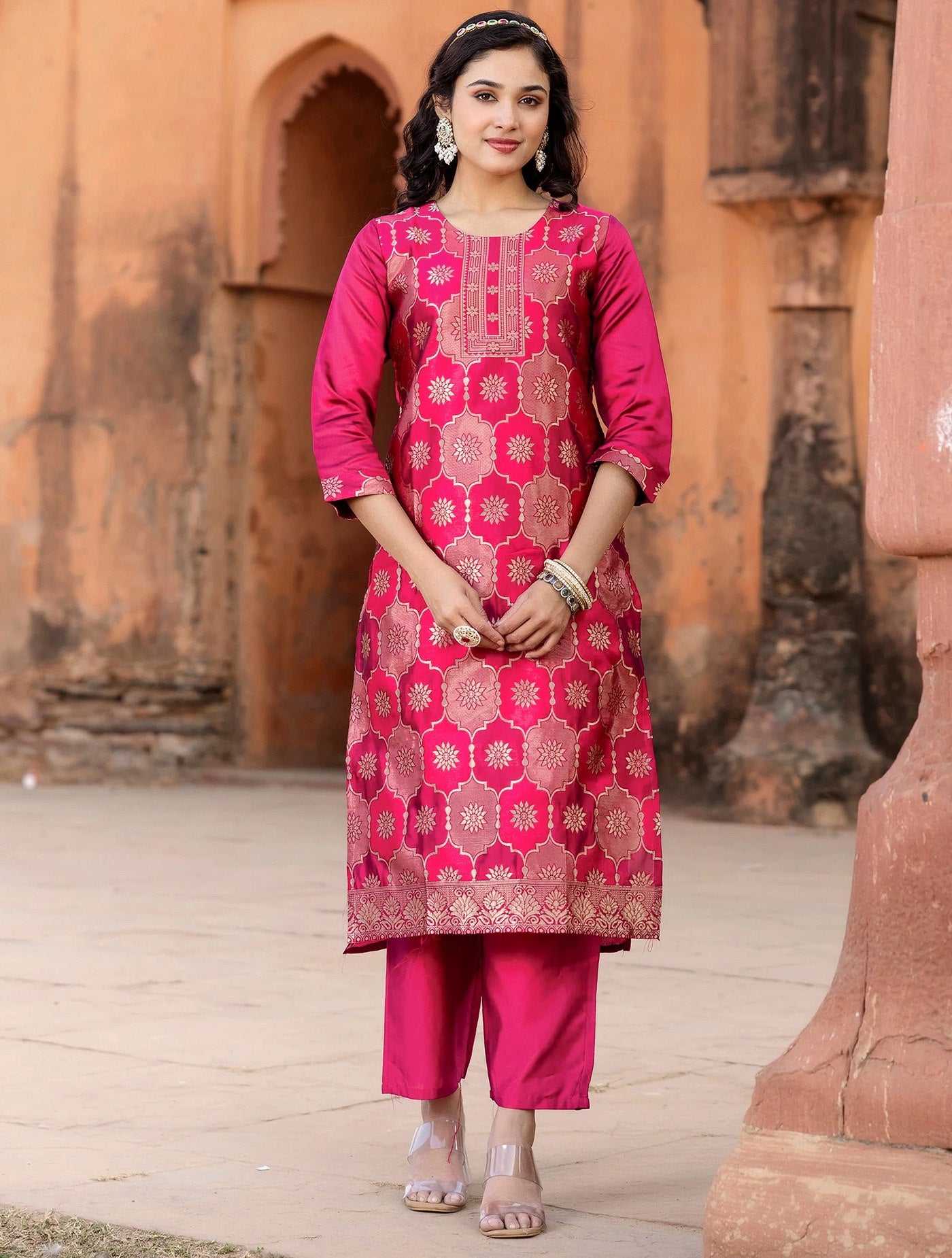 Traditional rani pink kurta with all-over gold weave work, matched with straight pants and a Banarasi brocade dupatta.
