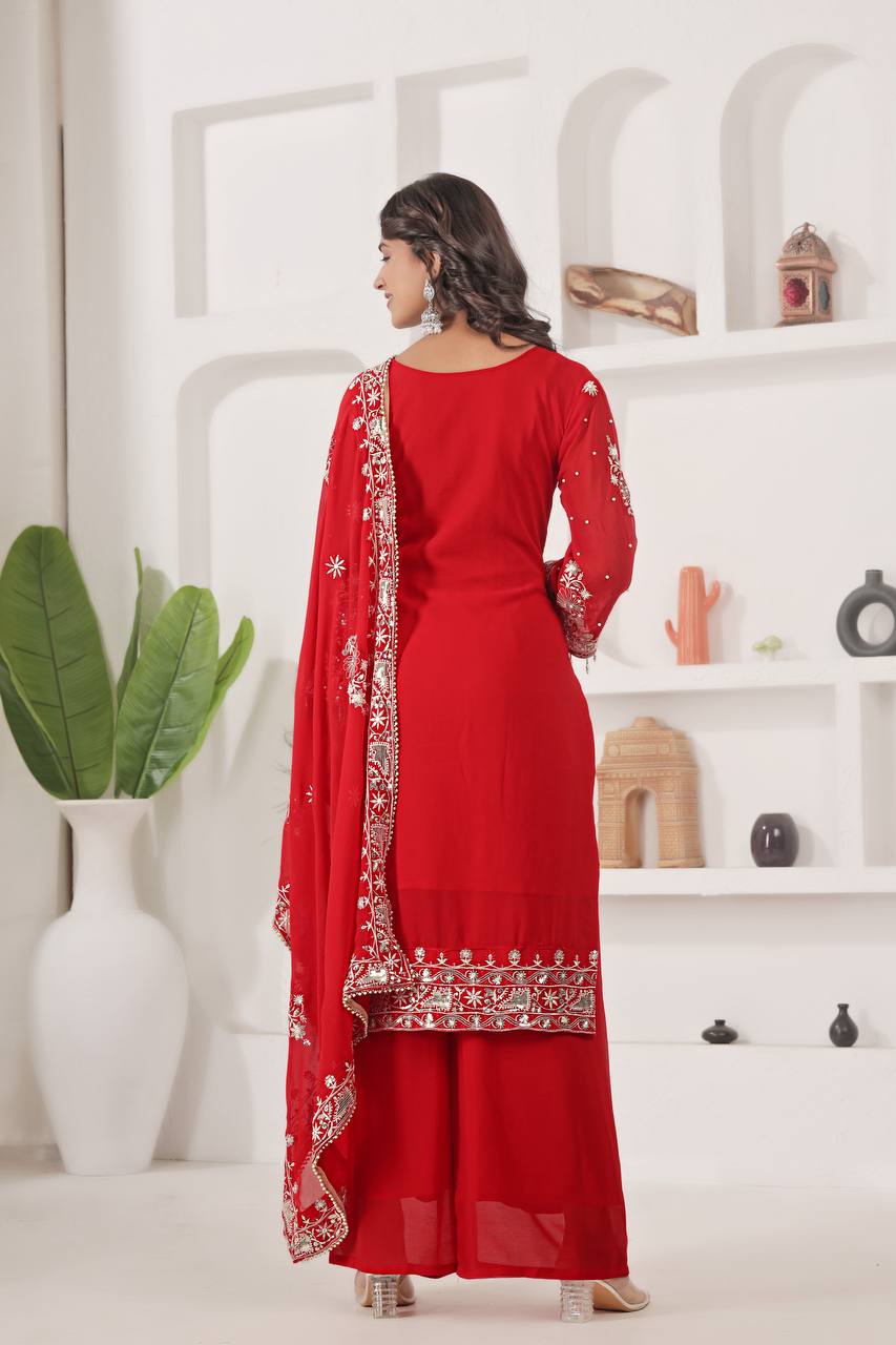 Traditional readymade red palazzo suit with intricate silver embroidery on the neckline, sleeves, and kurta hem, perfect for wedding ceremonies.