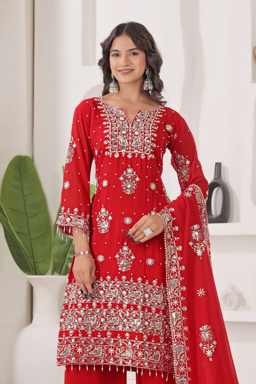 Vibrant scarlet red kurta with heavy silver embroidery, full sleeves, broad palazzo pants, and a matching embellished dupatta for a grand look.