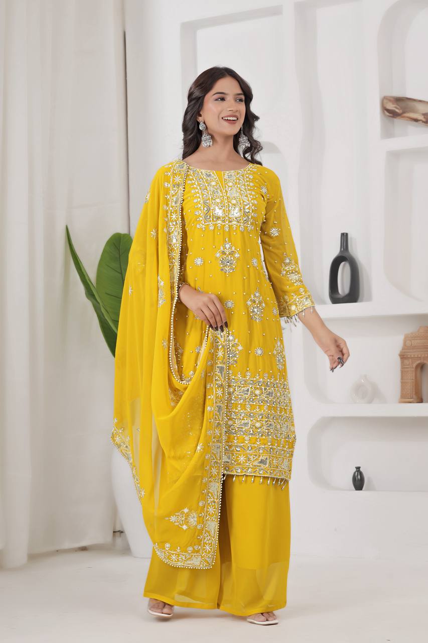 Vibrant yellow ethnic wear featuring a straight-cut kurta with heavy silver zari embroidery, mirror accents, and matching broad palazzo pants.