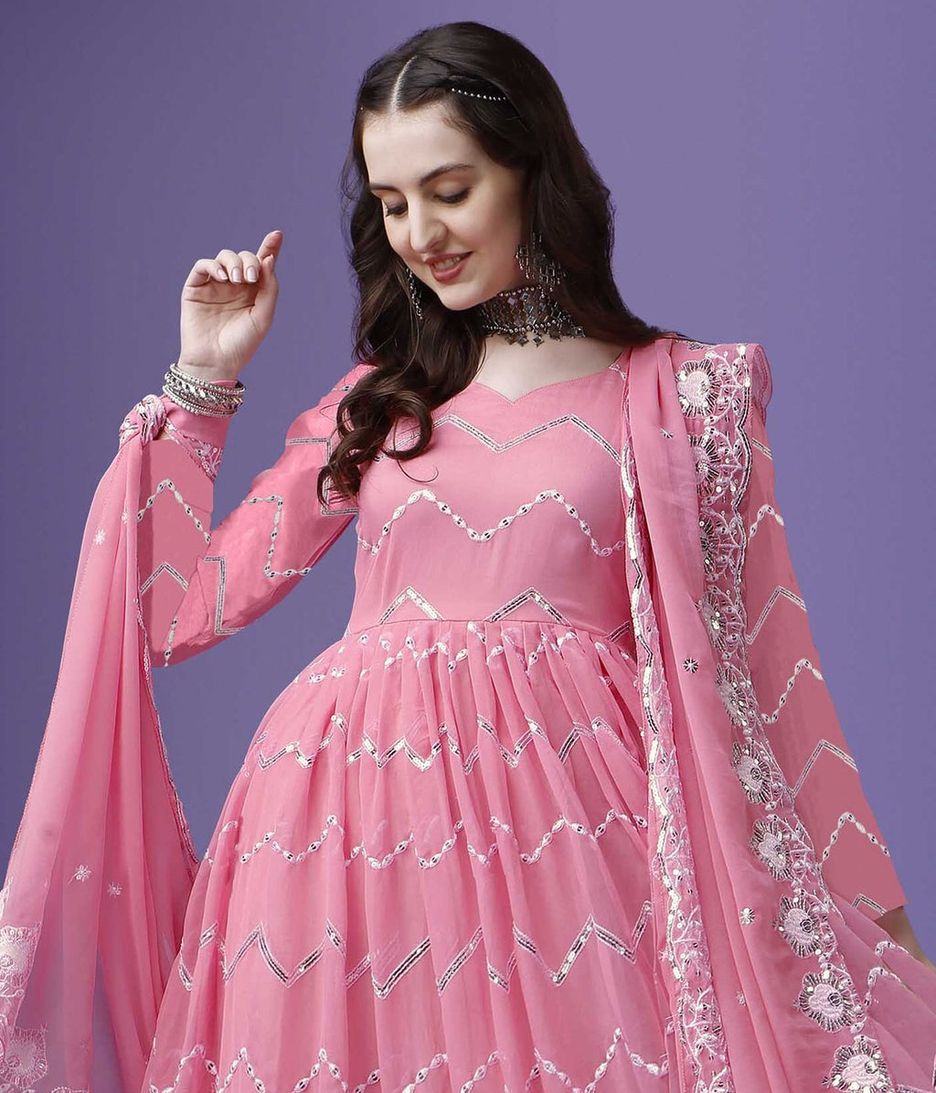 Model in a wedding and festive pink anarkali dress, featuring a voluminous flare and dazzling silver sequin work.
