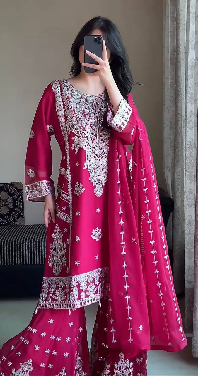 Model in a wedding guest pink gharara suit with full sleeves, intricate silver sequin embroidery on the kurta, and a tiered gharara with scattered sequins.